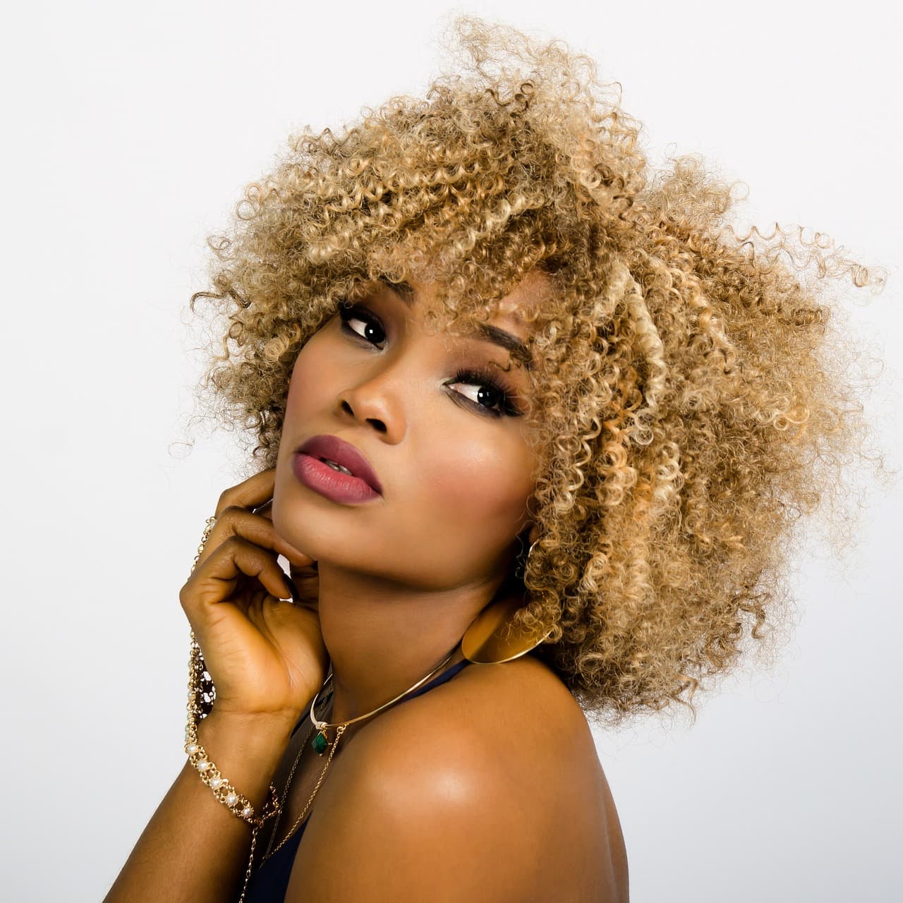 Big, honey-blonde curls framing a woman’s face